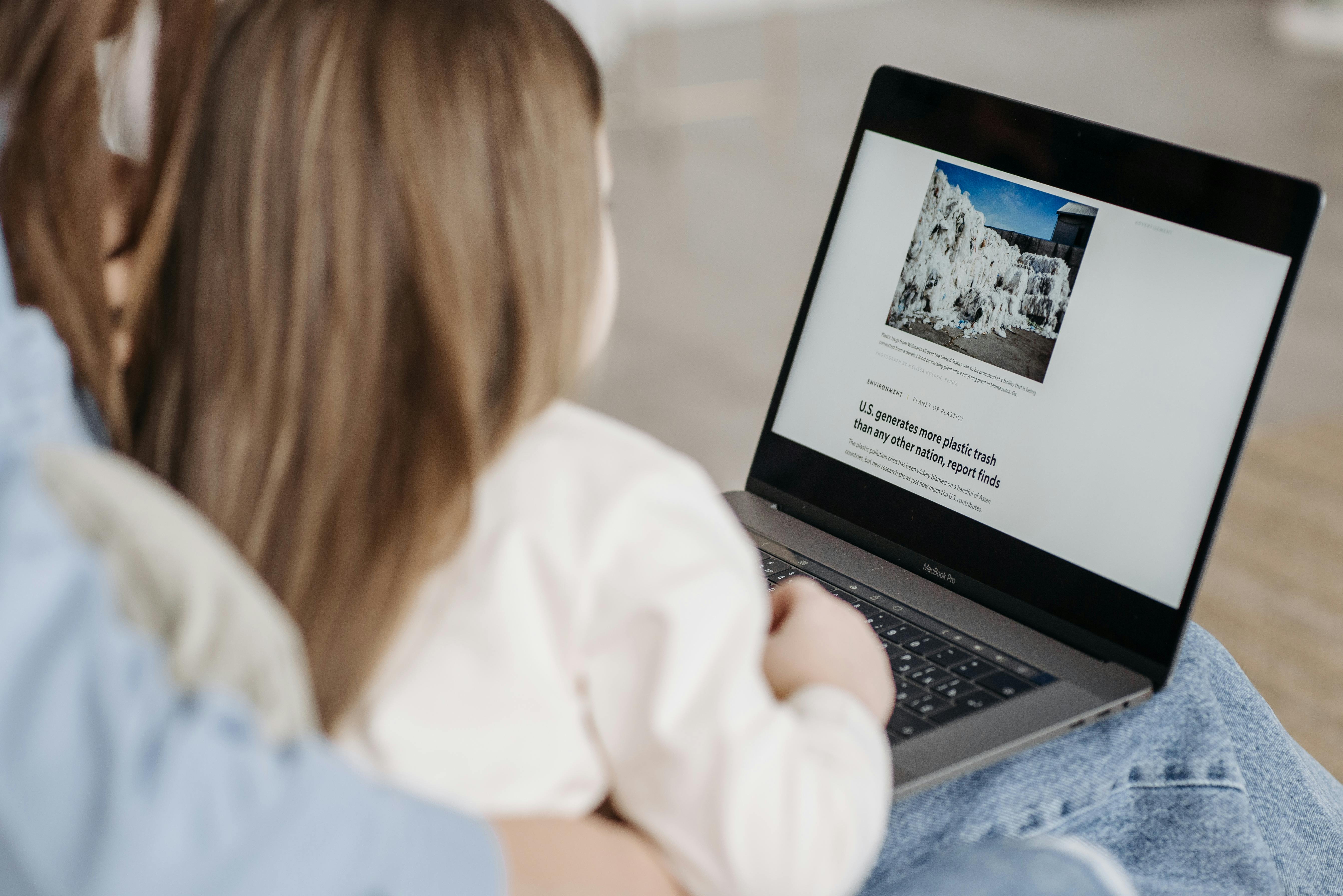 image of a child reading on a laptop